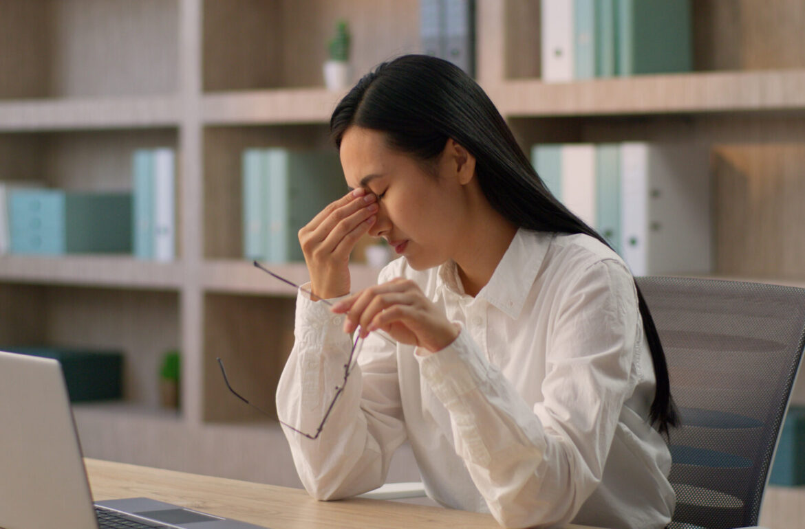 why are my eyes burning; Asian business woman suffering from burning eyes at work