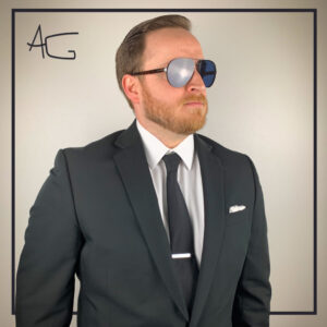 studio image of man in a suit wearing polarized prescription sunglasses