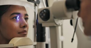 Close-up of an eye exam using a slit lamp light to check for early signs of diabetic retinopathy