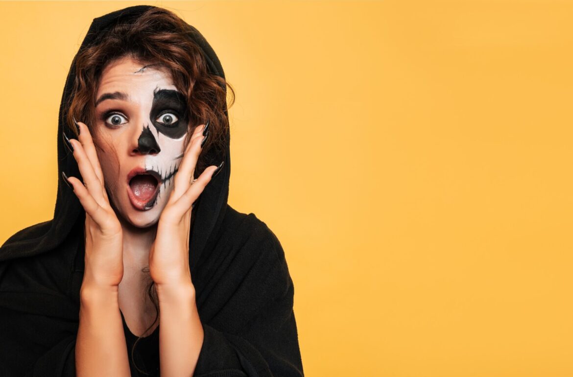teenage girl in black and white costume makeup wearing one-size-fits-all halloween contact lenses