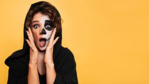 teenage girl in black and white costume makeup wearing one-size-fits-all halloween contact lenses